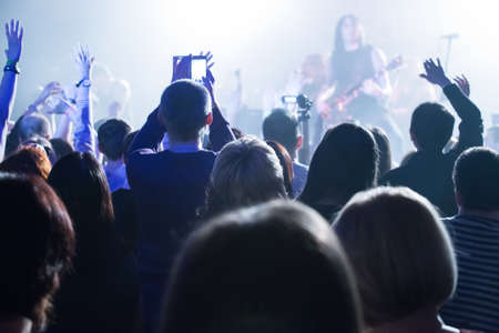 dancing audience at concert at nightclub