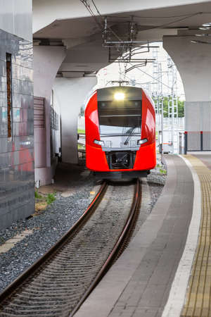 Modern red train approaching the train stationの写真素材