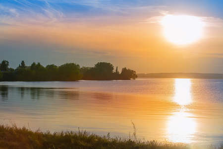 Beautiful sunset over the lake in summerの写真素材
