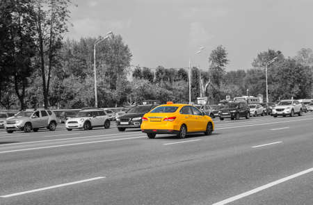Yellow taxi moves on the city street