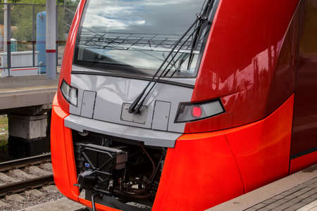 Modern red train approaching the train stationの写真素材