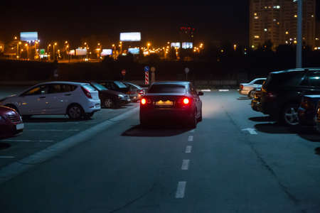 Cars at night in a parking lot in the city