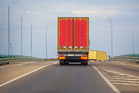 Wagons move in the evening on a country highwayの写真素材