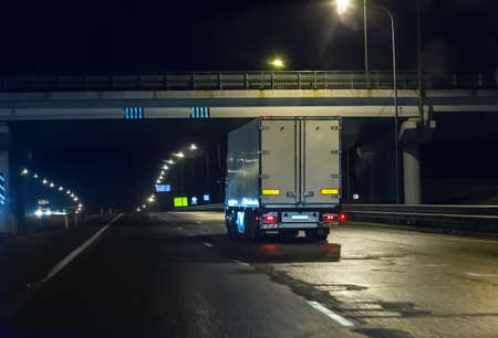 truck moves on country highway at nightの写真素材