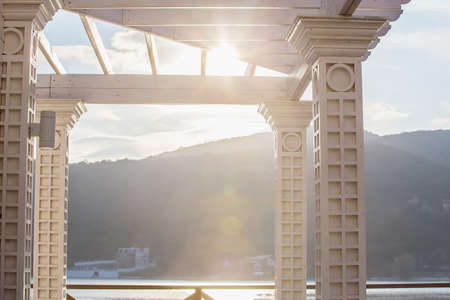 Classic arch against the backdrop of a mountainous landscapeの写真素材
