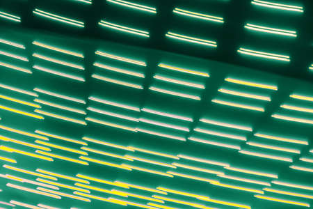 abstract light lines on dark green backgroundの写真素材