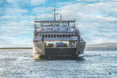 loaded ferry loaded with carsnmoves to another side of a sea.の写真素材