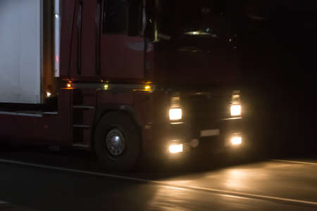 truck moves on country highway at nightの写真素材