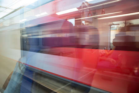 Train with passengers moving by rail. Blur close-up