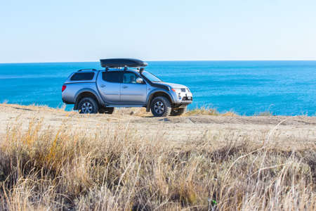 off-road vehicle on the high coast of the seaの写真素材