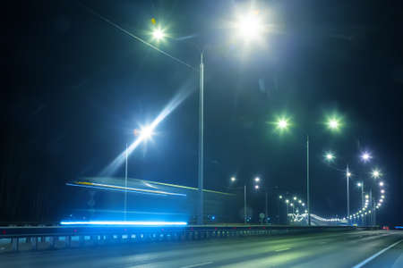 winter highway at night shined with lamps
