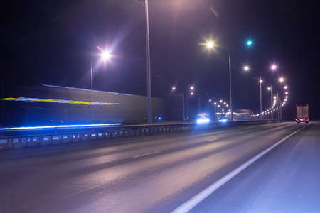 winter highway at night shined with lamps