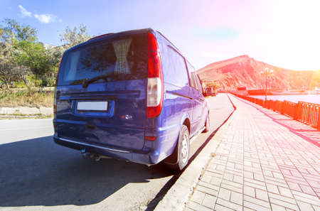 A minibus is parked on the embankment. Back view.のeditorial素材