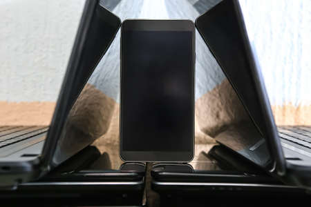 laptops with open monitors and a mobile telephone. Closeup.の写真素材