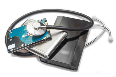 external hard drives and stethoscope on white background closeupの写真素材