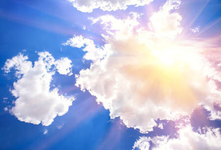 blue sky with clouds closing the sunの写真素材