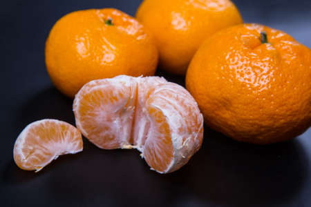 Ripe tangerines on a black background. Close-up.の写真素材