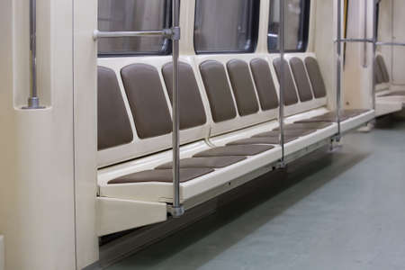 interior of the subway car with seats for passengers