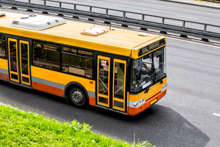 Yellow City Bus Moves along the Highway. View from aboveの写真素材
