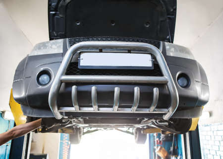 Car lifted at the workshop for maintenanceの写真素材