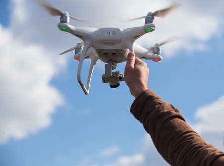 quadricopter with camcorder in male hand closeup