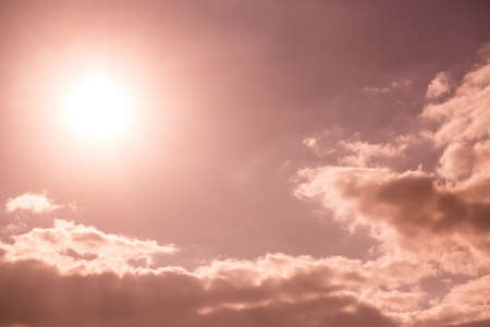 Beautiful dark sky with sun and cloudsの写真素材