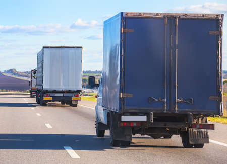 escort of trucks moves on mountain roadの写真素材
