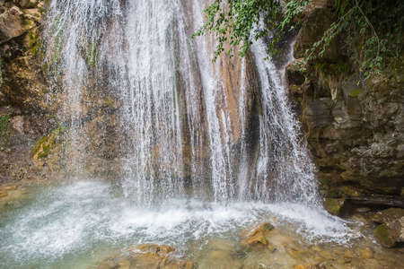 Roaring streams of water fall into lake. Wild life.の写真素材