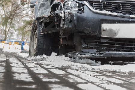 Crash a broken car in winter on the road under the snow. Close-up, detailの写真素材