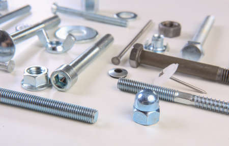 chromeplated bolts and nuts on white background
