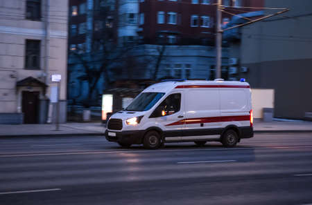 Ambulance goes on the night rainy cityの写真素材