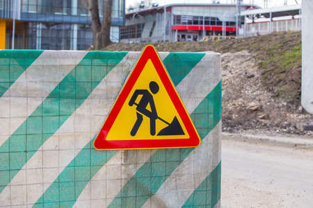 road sign construction works on the fence of the construction site