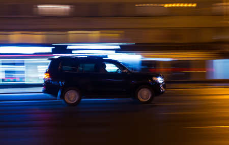 off-road car racing through the night Avenue. Blurred motionの写真素材