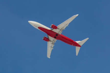 passenger plane flying in the sky bottom viewの写真素材