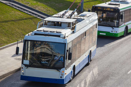 Trolleybus and bus at the bus stop. The view from the top.の写真素材