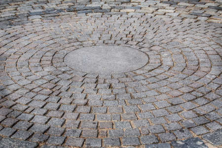 pavement of rough granite tiles in radial packingの写真素材