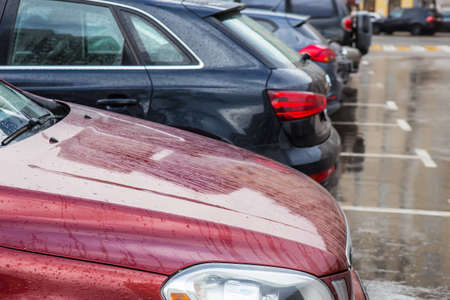 Modern cars are parked in a parking lot in row. Close-up. Concept of urban lifestyle.の写真素材