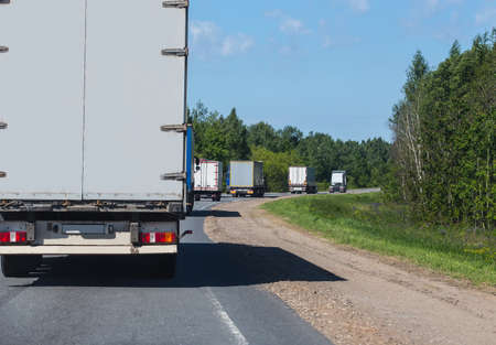 escort of trucks moves on roadの写真素材