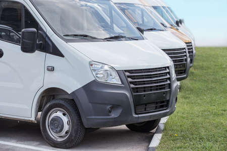 number of new white minibuses and vans outsideの写真素材
