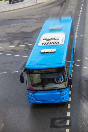 city bus moving on the road top view