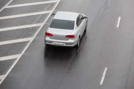 car moves on a wet multi-lane highway in the rain