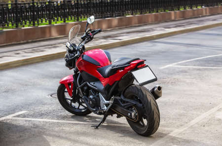 red motorcycle at the Parking lot in the city