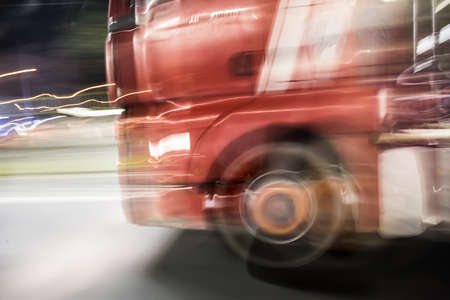 ?ruck rides on the highway at night. Blurred motion, close-up.