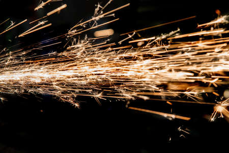 bright sparks of metal against dark background