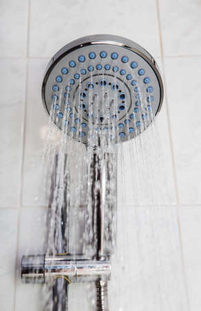 Shower head with flowing water jets. Close-up