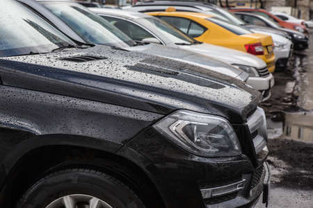 Modern cars are parked in a parking lot in row. Close-up. Concept of urban lifestyle.の写真素材