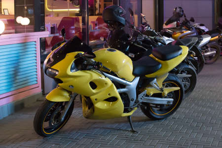 Motorcycles in the parking lot at the bar at nightの写真素材