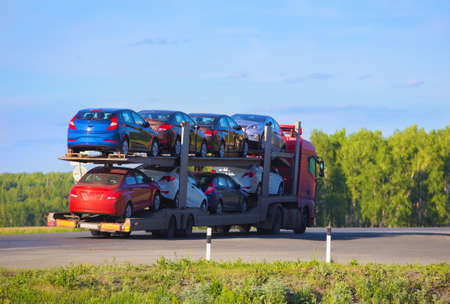 transportation of car on semi-trailer on country highway