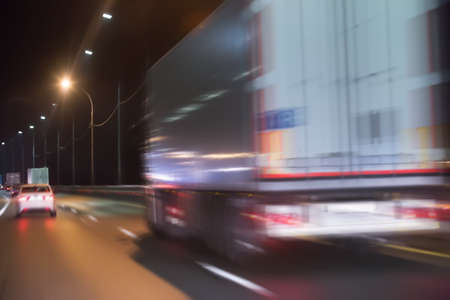 Truck moves on country highway at night.Blurred motionの写真素材