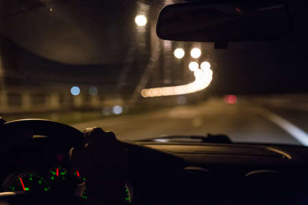 view from moving car on highway at nightの写真素材